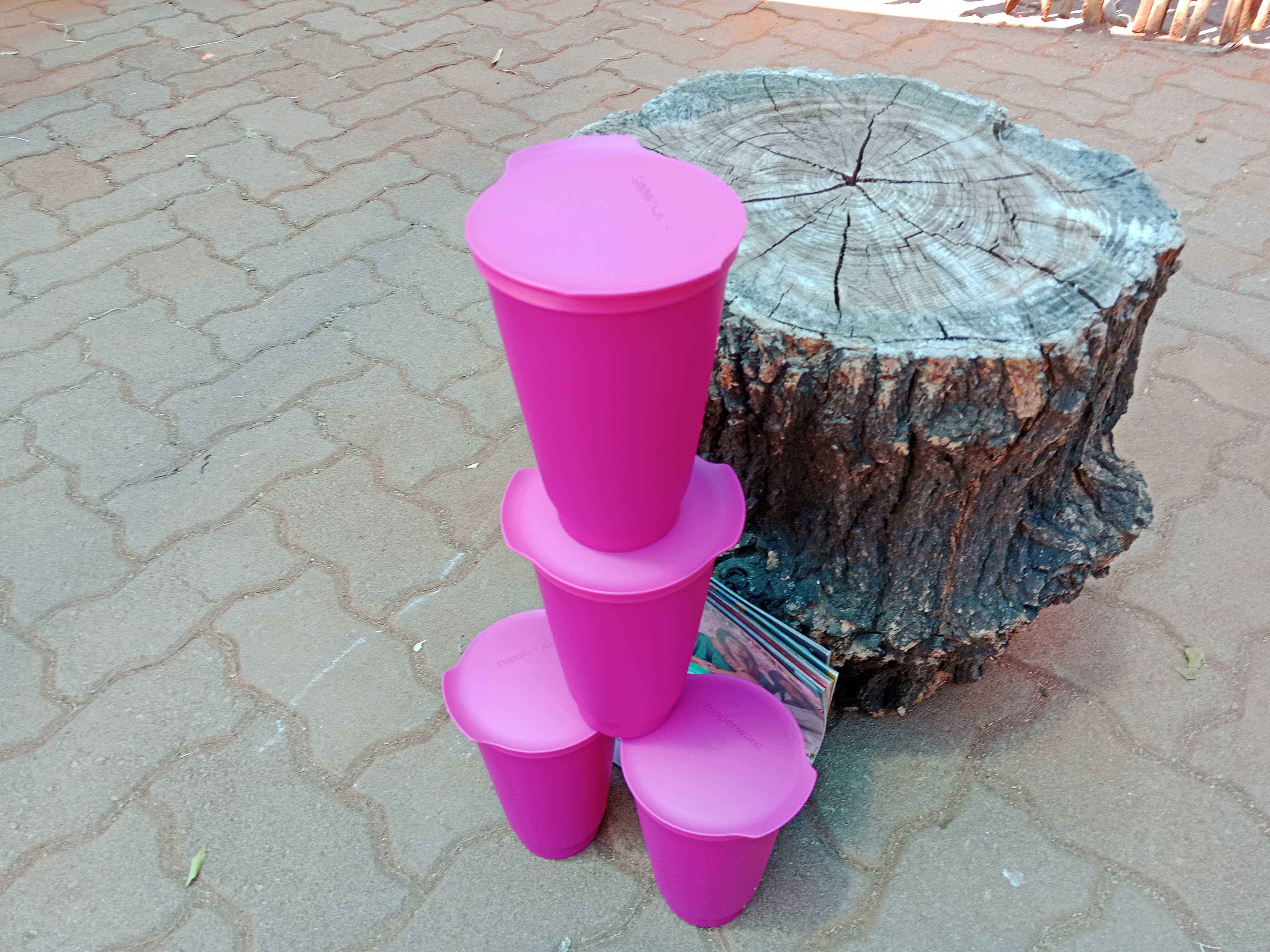 A set of Tupperware tumblers with leads